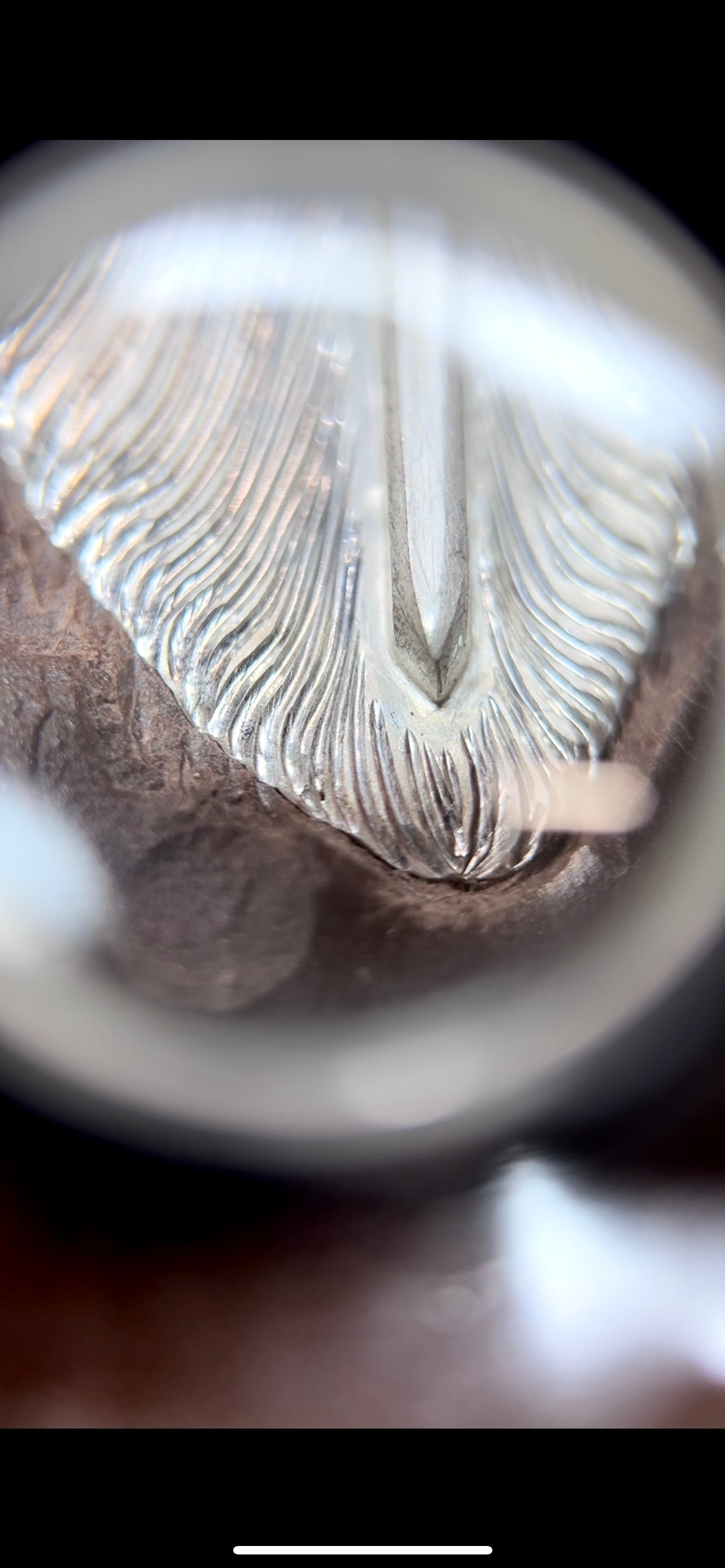 A close-up of chasing - working from the front, refining details.