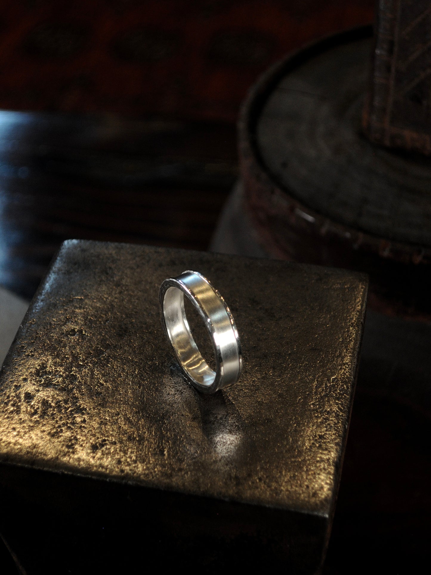 Hammer textured ring featuring hand forged border in sterling silver.