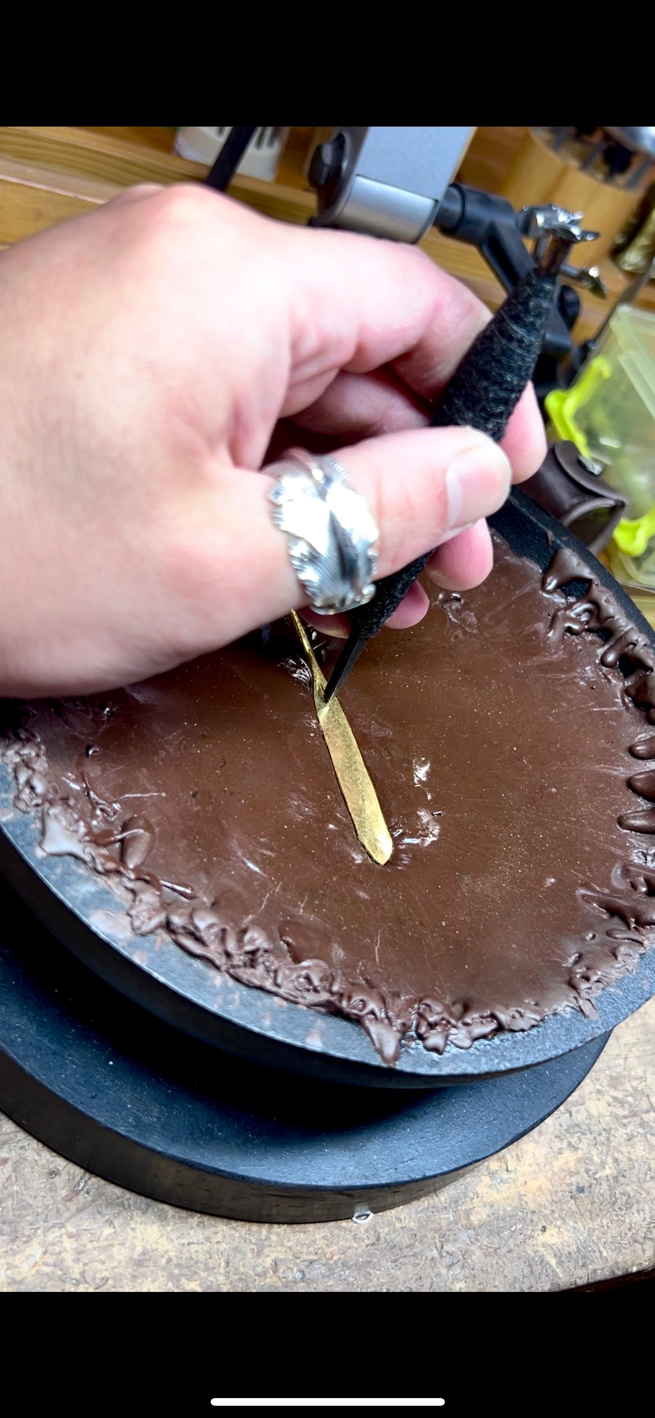 A close-up photo or diagram showing metal being hammered from the back.