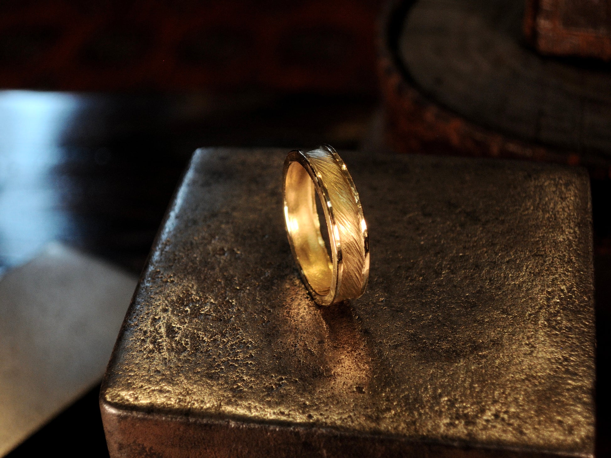 Hammer textured ring featuring water-like texture and hand forged border in 22k yellow gold.