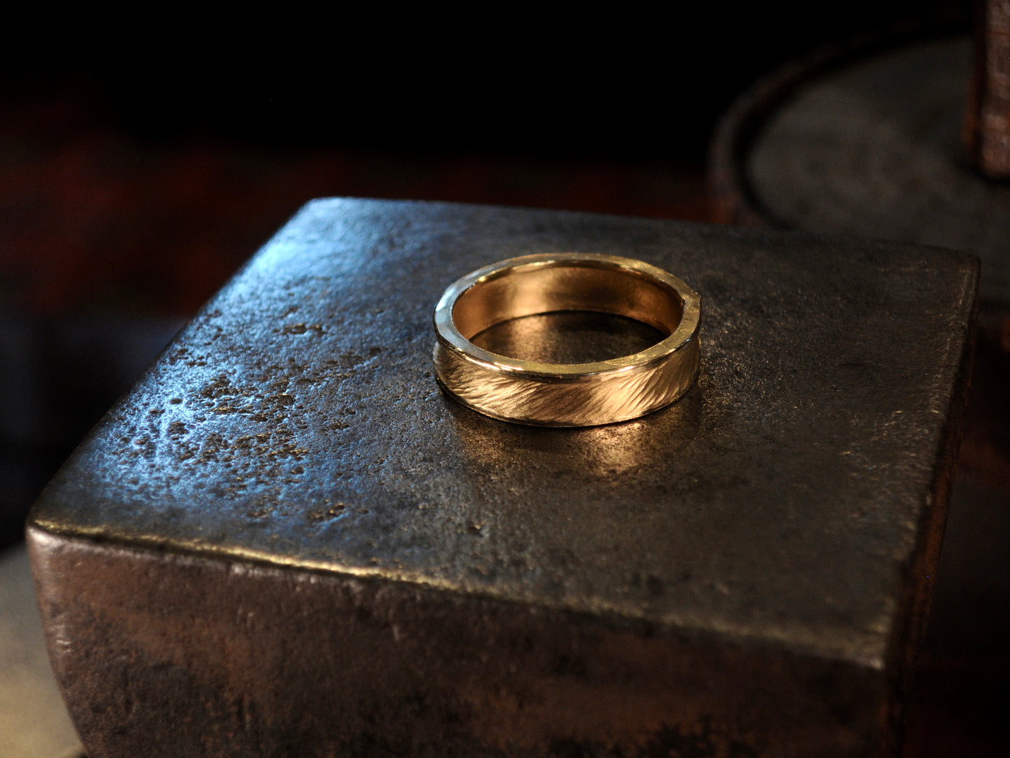 Hammer textured ring featuring water-like texture and hand forged border in 22k yellow gold.