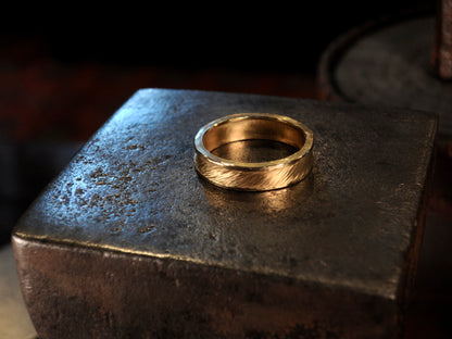 Hammer textured ring featuring water-like texture and hand forged border in 22k yellow gold.