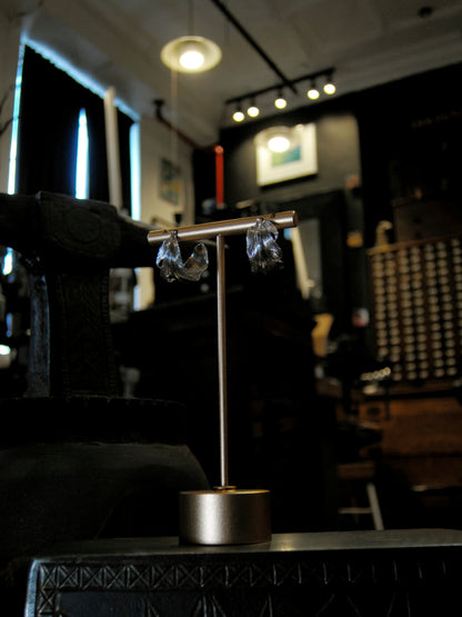 A pair of sterling silver feather earrings made using repousse and chasing techniques.