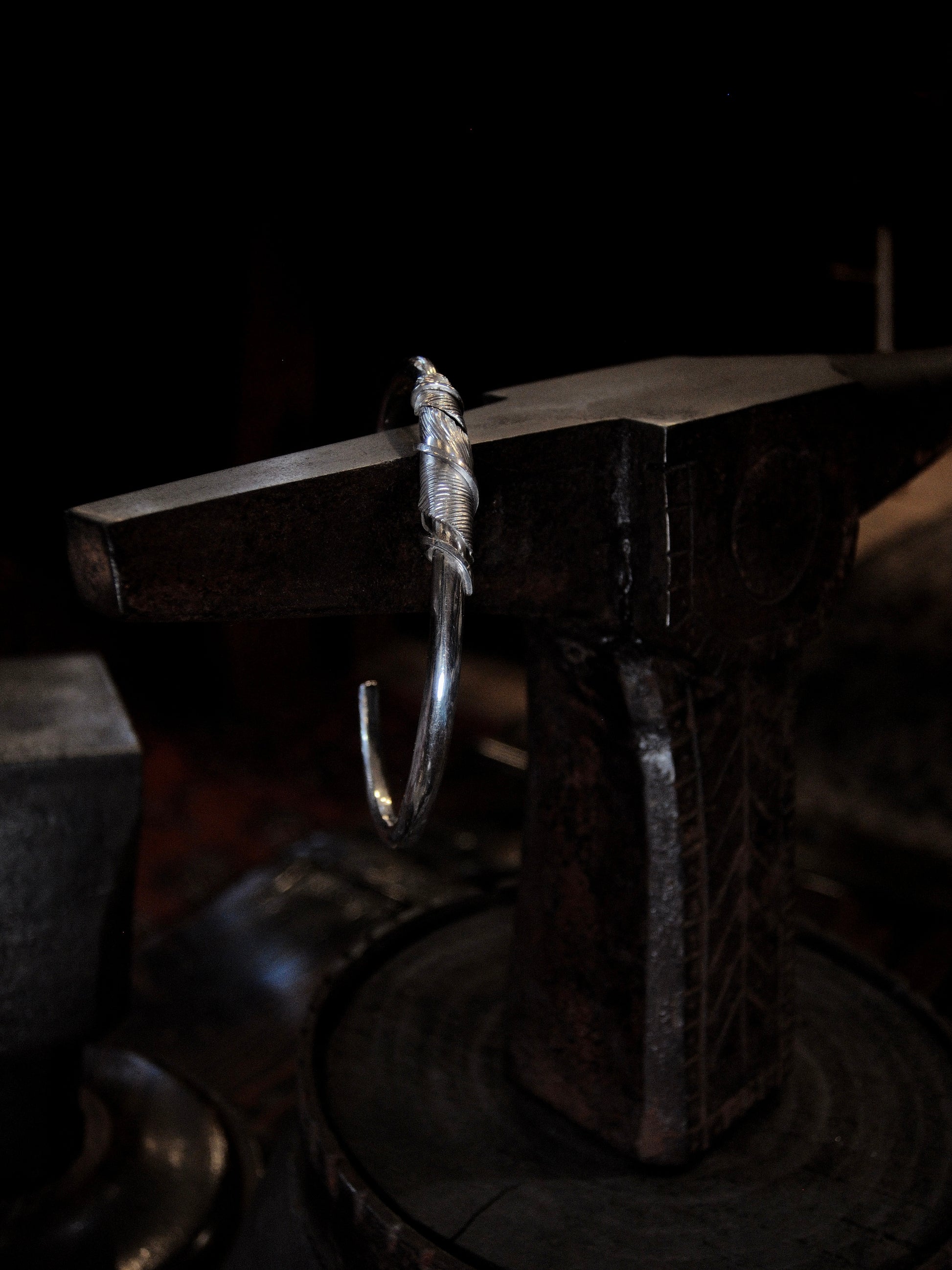 A sterling silver feather cuffs made using traditional repousse and chasing techniques