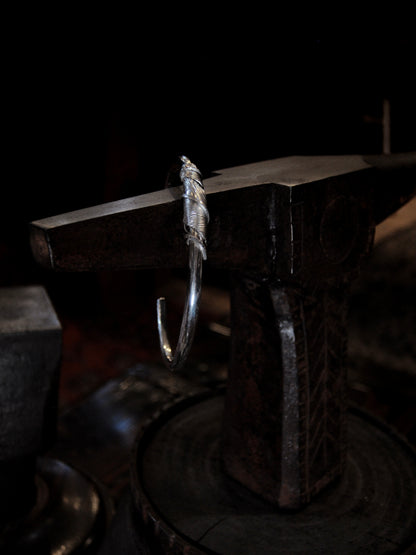 A sterling silver feather cuffs made using traditional repousse and chasing techniques