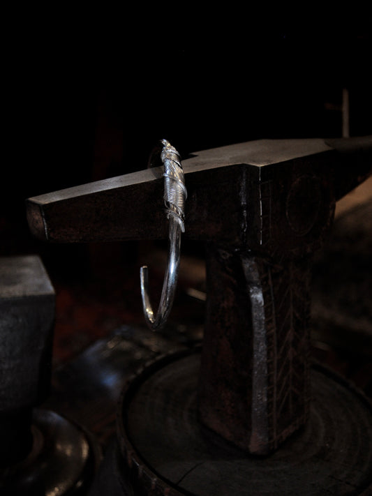 A sterling silver feather cuffs made using traditional repousse and chasing techniques