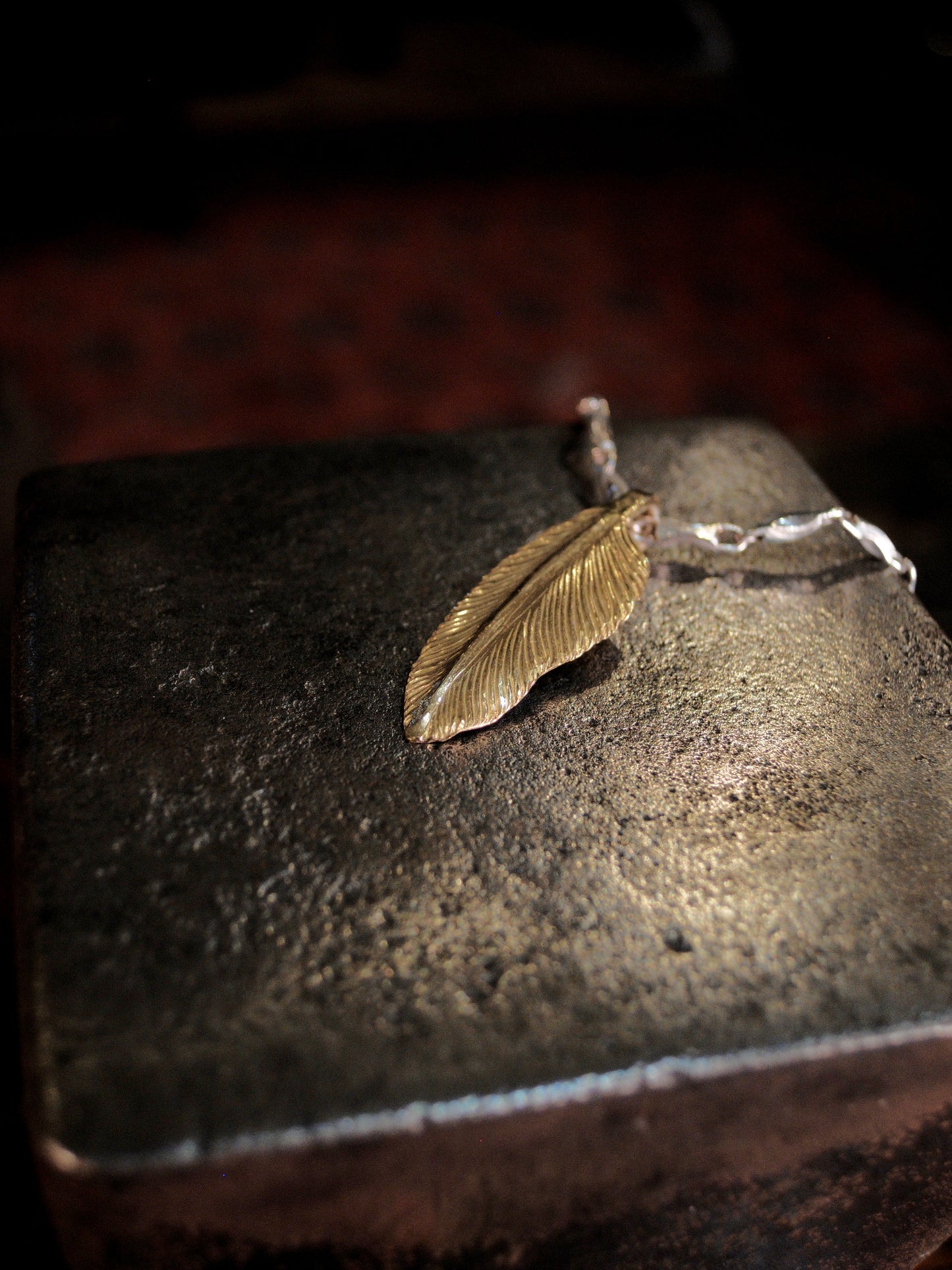 A 22k gold feather charm made using traditional repousse and chasing techniques. 