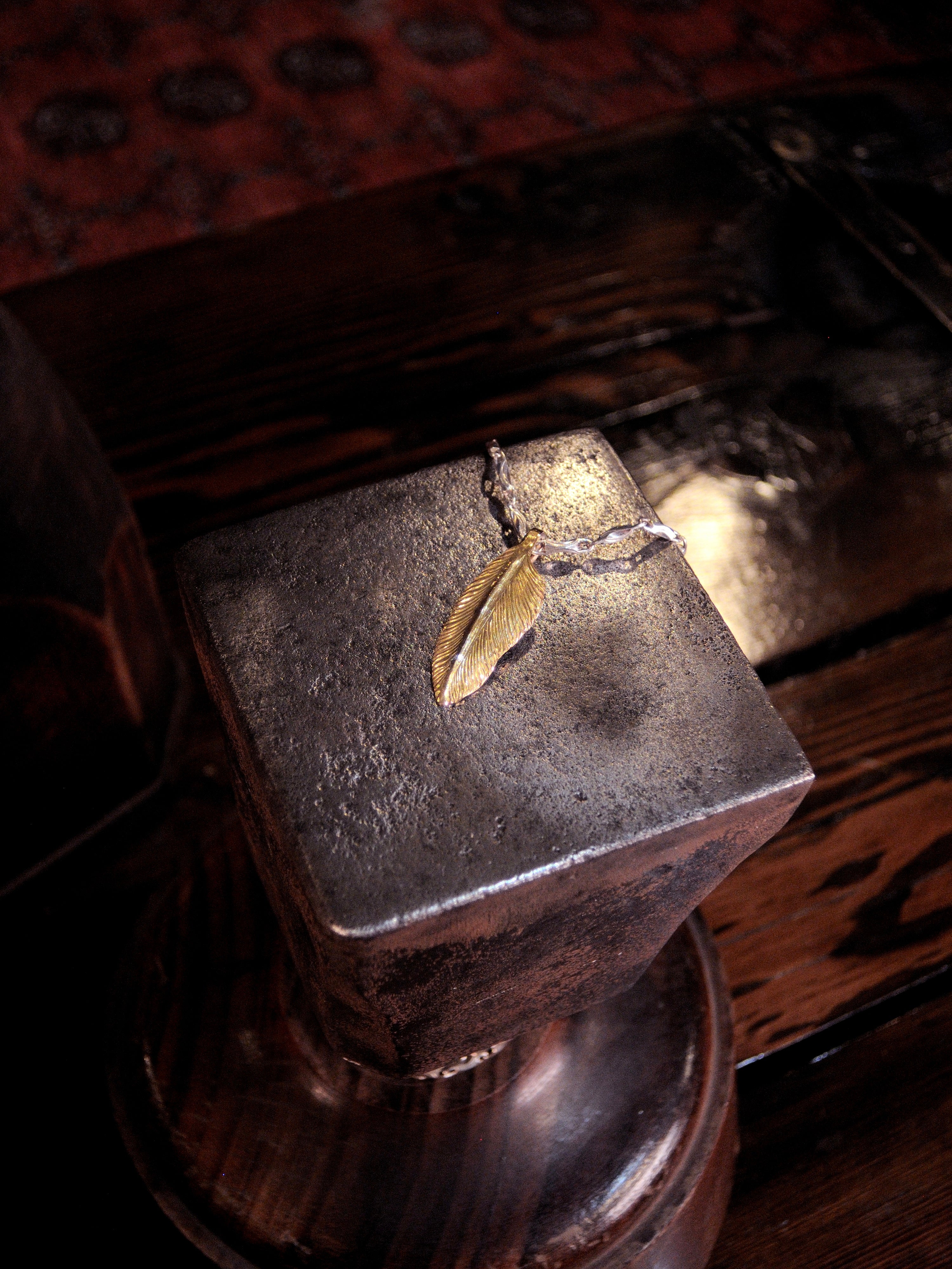 A 22k gold feather charm made using traditional repousse and chasing techniques. 