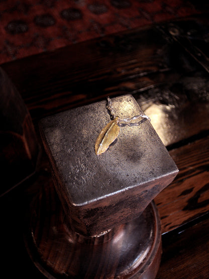 A 22k gold feather charm made using traditional repousse and chasing techniques. 