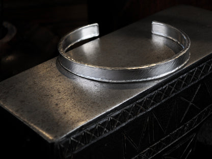 Hammer textured cuff featuring water-like texture and hand forged border in sterling silver.