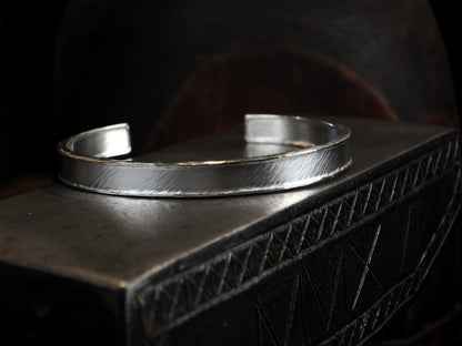 Hammer textured cuff featuring water-like texture and hand forged border in sterling silver.