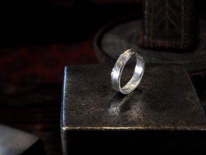Hammer textured ring featuring water-like texture and hand forged border in sterling silver.