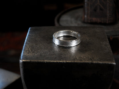 Hammer textured ring featuring water-like texture and hand forged border in sterling silver.