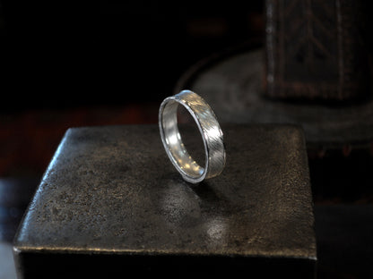 Hammer textured ring featuring water-like texture and hand forged border in sterling silver.