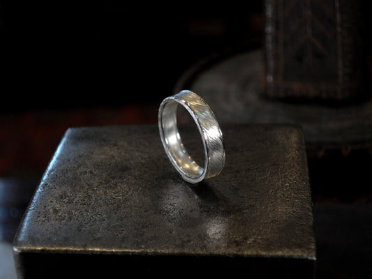 Hammer textured ring featuring water-like texture and hand forged border in sterling silver.